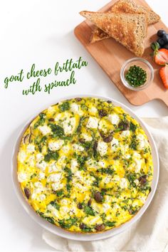 a cheese and vegetable pizza on a plate next to some bread, carrots and berries