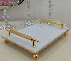 a white and gold tray with candles on it