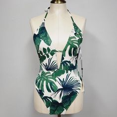 The Bikini Lab Womens Swimsuit Plunge Halter One Piece Floral Tropical New With Tags Medium Tropical Green Bodysuit For The Beach, Tropical Vacation Bodysuit With Lined Body, Tropical Bodysuit With Lined Body For Vacation, Green Triangle Top Bodysuit For Poolside, Green Halter Neck Bodysuit For Poolside, White V-neck Tropical Swimwear, White Halter Neck Bodysuit For Beach, White One-piece Swimwear With Tropical Print, Green Triangle Top Bodysuit For Beach Season