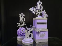 purple and silver birthday decorations on display in front of a black background with the number 16