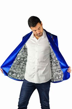 This mens royal blue velvet smoking jacket exudes a certain sophistication that other jackets can only dream of. We have taken this perfectly tailored,double breasted blazer to the next level with the addition of iridescent multi color flip sequins. FEATURES: Double breasted Fully lined with our signature satin 4 pockets including 1 inside breast pocket Reversible iridescent sequin contrast collar, cuffs and trim Velvet trimmed collar to for ultimate comfort Ethically made in-house in our studio Royal Fitted Blazer For Party, Velvet Tuxedo Outerwear, Fitted Velvet Tuxedo Style Outerwear, Fitted Velvet Tuxedo Outerwear, Blue Party Outerwear With Lapel Collar, Royal Blue Party Blazer, Blue Velvet Winter Outerwear, Fitted Luxury Velvet Outerwear, Luxury Fitted Velvet Outerwear