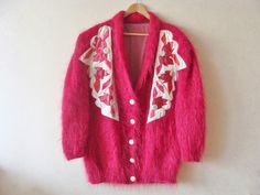 "90s super soft fuzzy knit cardigan coat in fuschia pink/ raspberry color. Long and slouchy with a long open v-neck front, floral embroidery, statement puffed shoulders, side pockets and 5 big satin coated button closures. Two side pockets. Fully lined with big shoulder pads (easy to remove). Super cozy. Dry Clean. Team it with minimalist dress or leather trousers for an understated elegant mood. Condition: Very good, lightly loved. There is some discoloration on the button, but you can change i Fuzzy Mohair Sweater, Pull Mohair, Patchwork Embroidery, Satin Coat, Minimalist Dress, Pink Raspberry, Patchwork Coat, Oversized Sweater Cardigan, Cardigan Oversized