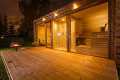 a wooden deck with lights on it and a hot tub in the background