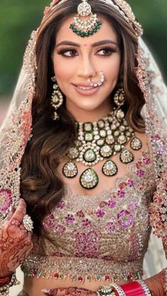 a woman wearing a bridal outfit and jewelry