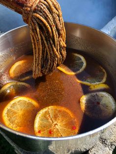 a pot filled with liquid and lemon slices