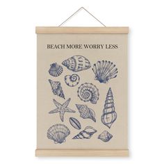 a blue and white poster hanging on a wall next to a wooden sign that says beach more worry less