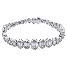 This diamond tennis bracelet is unique and an eye catcher! The baguettes are graduated in the design with the round brilliant diamonds on the outside shoulders. The contrast of the brilliant round diamonds against the crisp, white baguettes is remarkable and will grasp everyone's attention! The mounting is made in 18k white gold and is perfect for any occasion - smart casual to formal events! Diamonds: 6.49 cts, Baguette, Round Brilliant Metal: 18k White Gold Luxury Platinum Diamond Bracelet With Baguette Diamonds, Diamond White Platinum Bracelet With Baguette Diamonds, Platinum Diamond Bracelet With Baguette Diamonds In Diamond White, Timeless Tennis Bracelet With Baguette Diamonds, Luxury Diamond Tennis Bracelet With Baguette Cut, Luxury Diamond Tennis Bracelet Baguette Cut, Luxury Round Tennis Bracelet With Baguette Diamonds, Diamond Tennis Bracelet With Baguette Cut Accents, Baguette Cut Diamond Tennis Bracelet With Accents