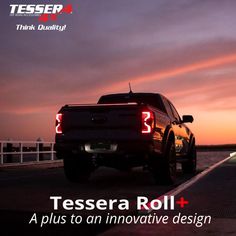 the back end of a pickup truck with its tail lights on at dusk, and an advertisement for tessena roll plus