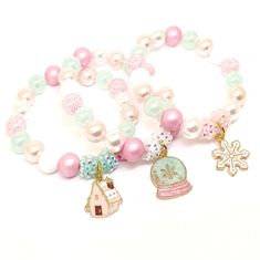 These adorable bracelets are the perfect gifts for your little one's classmates! Each bracelet features a pastel Christmas theme enamel charm, resin rhinestone beads and an assortment of pale pink, white, pink and pale blue green 10mm acrylic beads strung with durable stretch cord. Each bracelet comes individually packaged in organza bags. This charm mix includes a gingerbread house, a snowflake and a snowglobe. You will receive a mix of charms. Please message me if you have any questions or if Blue Gingerbread House, Pink Gingerbread, Bracelets Pink, Snowflake Bracelet, Ballerina Jewelry, Snowman Snowflake, Pastel Christmas, Birthday Bracelet, Christmas Bracelet