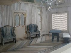 a room with two chairs and a chandelier