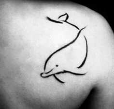 a black and white photo of a dolphin tattoo