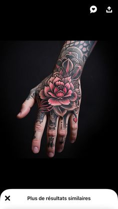 a person's hand with tattoos and flowers on it