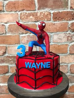 a spiderman birthday cake with the number three on it