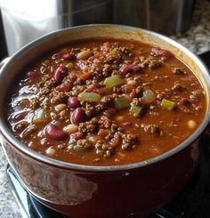 a pot filled with chili and beans on top of a stove