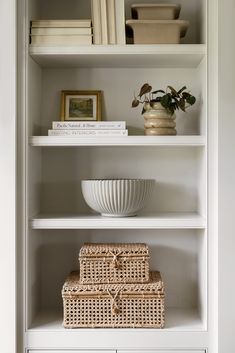 white shelves with wicker baskets and books