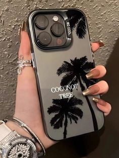 a woman holding up her phone case with the words coconut tree on it and palm trees