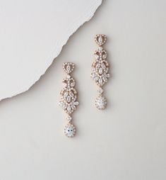 "These beautiful earrings are a lovely combination of round, marquise and teardrop CZ gemstones. All set in a lovely rhodium or rose gold finish, these drop earrings are a lovely accessory for brides and bridesmaids alike. Earrings measure: 2-3/8\" x 5/8\" Matching necklace; https://www.etsy.com/listing/265247660/rose-gold-necklace-crystal-bridal Bracelet: https://www.etsy.com/listing/280318514/rose-gold-bracelet-crystal-bridal" Elegant Rose Gold Chandelier Earrings, Rose Gold Drop Crystal Earrings For Wedding, Rose Gold Crystal Chandelier Dangle Earrings, Rose Gold Crystal Dangle Chandelier Earrings, Glamorous Rose Gold Dangle Bridal Earrings, Rose Gold Crystal Bridal Earrings For Wedding, Rose Gold Crystal Chandelier Drop Earrings, Rose Gold Crystal Chandelier Earrings, Rose Gold Crystal Teardrop Earrings