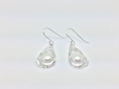 Hi everyone, just wanted to let you know we are open and shipping daily. Beautifully crafted handmade pearl and sterling silver dangle earrings. Features perfectly matched hand picked South Sea Pearls in a stunning silver setting so unique you will not go unnoticed. This line of pearl jewelry makes excellent brides made gifts and has been a top seller in our San Francisco jewelry store for years. Unique Sterling Silver Pearl Drop Earrings, Handmade Silver Pearl Earrings, Handmade Distinctive Silver Pearl Earrings, Unique Handmade Silver Pearl Earrings, Unique Silver Pearl Drop Earrings, Pierced Teardrop Pearl Earrings In Sterling Silver, Handmade Sterling Silver Pearl Earrings For Gift, Handmade Silver Pearl Earrings For Anniversary, Handmade Silver Pearl Earrings For Gift