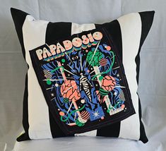 a black and white pillow with the words papabasio on it