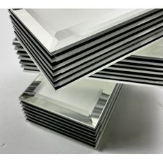 stack of metal plates stacked on top of each other in front of a white background