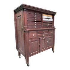 an old wooden cabinet with drawers and wheels on the bottom shelf is isolated against a white background