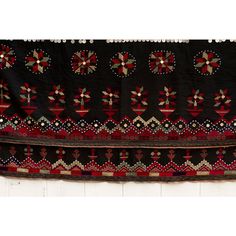 This fabulous antique Kohistani shawl whispers stories of the Mangal people, inhabiting the borderlands of eastern Afghanistan and western Pakistan. This antique shawl was Traditionally worn by women as a head covering during wedding or ceremonies, this piece is a testament to the Mangal's artistry and cultural heritage. Hand-crafted from heavy black cotton, the shawl is adorned with intricate silk embroidery. Geometric and floral motifs in vibrant colors like red, green and yellow dance across Ceremonial Shawl With Embroidered Border And Traditional Drape, Ceremonial Shawl With Embroidered Border, Traditional Shawl-style Dupatta With Border, Traditional Dupatta Shawl With Border, Traditional Shawl Shaped Dupatta With Border, Traditional Dupatta With Border In Shawl Shape, Bohemian Ceremonial Shawl With Motifs, Ceremonial Traditional Shawl, Bohemian Shawl With Motifs For Ceremonial Use