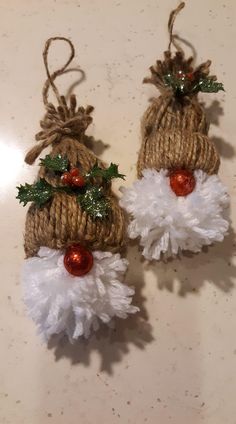 two burlap christmas decorations with holly and berries