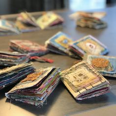 many different colored papers on a table with one folded up and the other half open