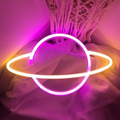 a light up object sitting on top of a bed