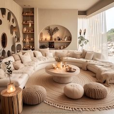 a living room filled with white furniture and lots of pillows on top of the couches