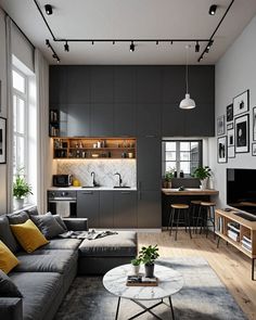 a living room filled with furniture and a flat screen tv mounted to the side of a wall