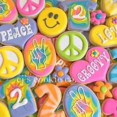 decorated cookies with peace, love, and happy words are shown in the image above