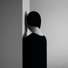 a person standing in front of a wall with their back turned to the camera,