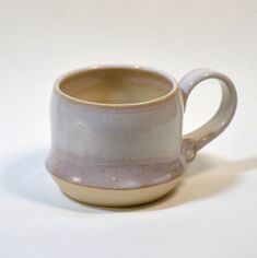 a coffee cup sitting on top of a white table