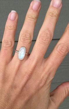 A beautiful oval rainbow moonstone has been set in sterling silver with a hand made ring band from sterling silver half dome wire. The moonstone is 16mm x 8mm in size. Simple and elegant in size! Made to order! Choose your setting, vertical (north to south) or horizontal (east to west). Moonstone is the birthstone for June! June Birthstone Ring, Ring Moonstone, Moonstone Ring Sterling Silver, Moon Glow, June Birthstone, Window Shopping, Half Dome, Moonstone Ring, June Birth Stone