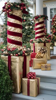 christmas presents are wrapped in gold and red ribbons on the front steps of a house