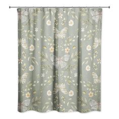 a blue shower curtain with white flowers and butterflies on the curtains is hanging from a metal rod