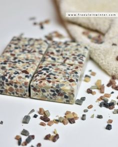 two bars of soap sitting next to each other on a white surface with scattered confetti