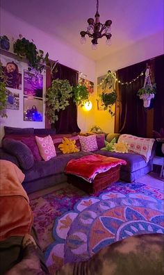 a living room filled with purple couches and lots of plants on top of them