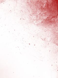 an abstract red and white background with some paint splattered on the wall,