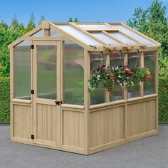 a small wooden greenhouse with flowers in the potted planter and hanging plants on the side