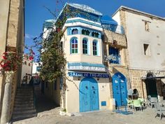 a blue and white building with stairs leading up to it