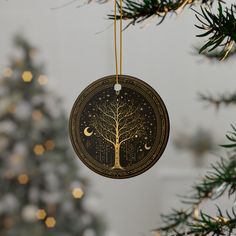 an ornament hanging from a christmas tree with the moon and stars on it