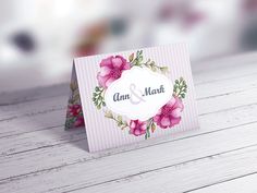 a close up of a greeting card on a wooden table with white wood planks