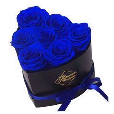 a heart shaped box filled with blue roses