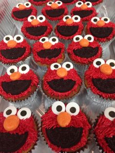 cupcakes with red frosting and black icing decorated like sesame street characters