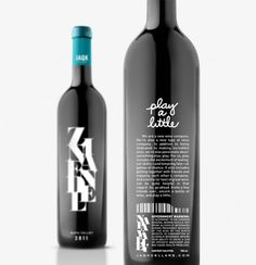 two bottles of wine are next to each other on a white surface, one is black and the other is teal