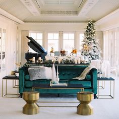 a living room filled with furniture and a christmas tree