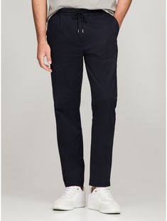 Tommy Hilfiger men's pant. Beyond comfortable, these chinos have an elastic waistband, mastering the dressed-up meets dressed-down pairing. They're cut in a relaxed tapered fit from garment-dyed cotton twill for an ultra-soft feel.  Material: 77% Cotton, 20% Reprocessed Cotton, 3% Elastane. Elevated Casual Tapered Leg Chinos With Elastic Waistband, Elastic Waistband Tapered Leg Chinos For Elevated Casual, Modern Relaxed Fit Cotton Chinos, Relaxed Fit Chinos With Tapered Leg And Comfort Waistband, Tommy Hilfiger Tapered Leg Bottoms With Pockets, Tommy Hilfiger Tapered Leg Pants With Pockets, Casual Chinos With Elastic Waistband And Tapered Leg, Modern Relaxed Fit Tapered Leg Chinos, Casual Tapered Chinos With Relaxed Fit