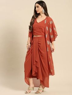 Look your absolute best as you head out this festive season wearing this Fusion Set. Crafted using the finest georgette fabric, this apparel will surely make you stand out. Complement this outfit with a pair of high-heels and chunky gold jewelry to complete your look. Material: Georgette Wash Care: Dry-clean Pattern: Printed Style: Crop Top With Dhoti Skirt Set, Crop Top With Dhoti Skirt And Jacket/Shrug Set, Dhoti Suit Set, Indo Western Dress, Indian Dress For Women Sizes: To Fit Bust(in inches Traditional V-neck Party Sets, Summer Party Chiffon Sets, Georgette Party Wear Pre-draped Saree For Navratri, Designer Summer Party Wear Sets, Summer Party Wear Designer Sets, Draped Party Sets With Pallu, Bollywood Draped Party Sets, Festive Draped Sets For Festivals, Festive Draped Party Sets